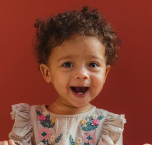 baby girl wearing grey dress and white socks